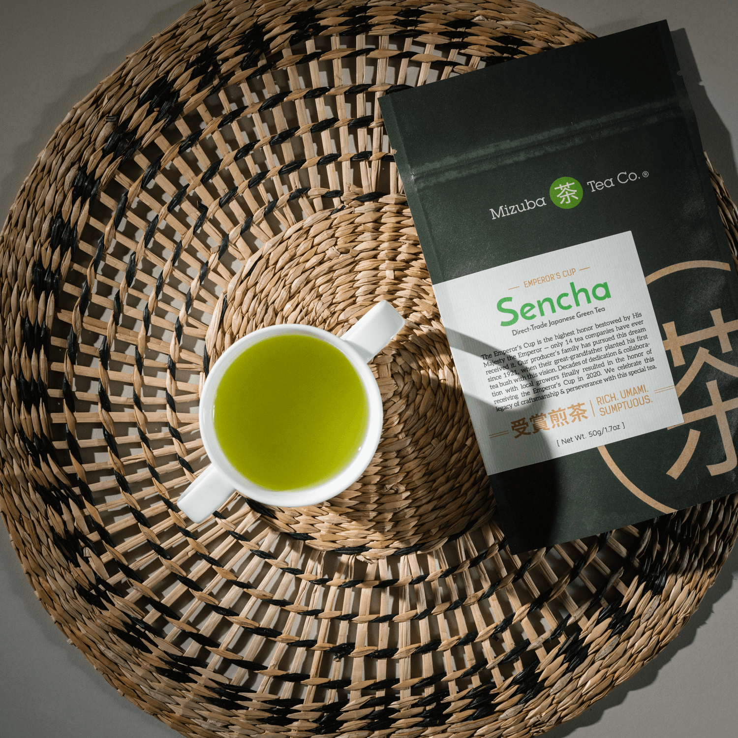 Top down view of Sencha tea in a cup and the packaging