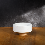 white speckled chawan on a brown table