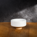 white speckled chawan on a brown table