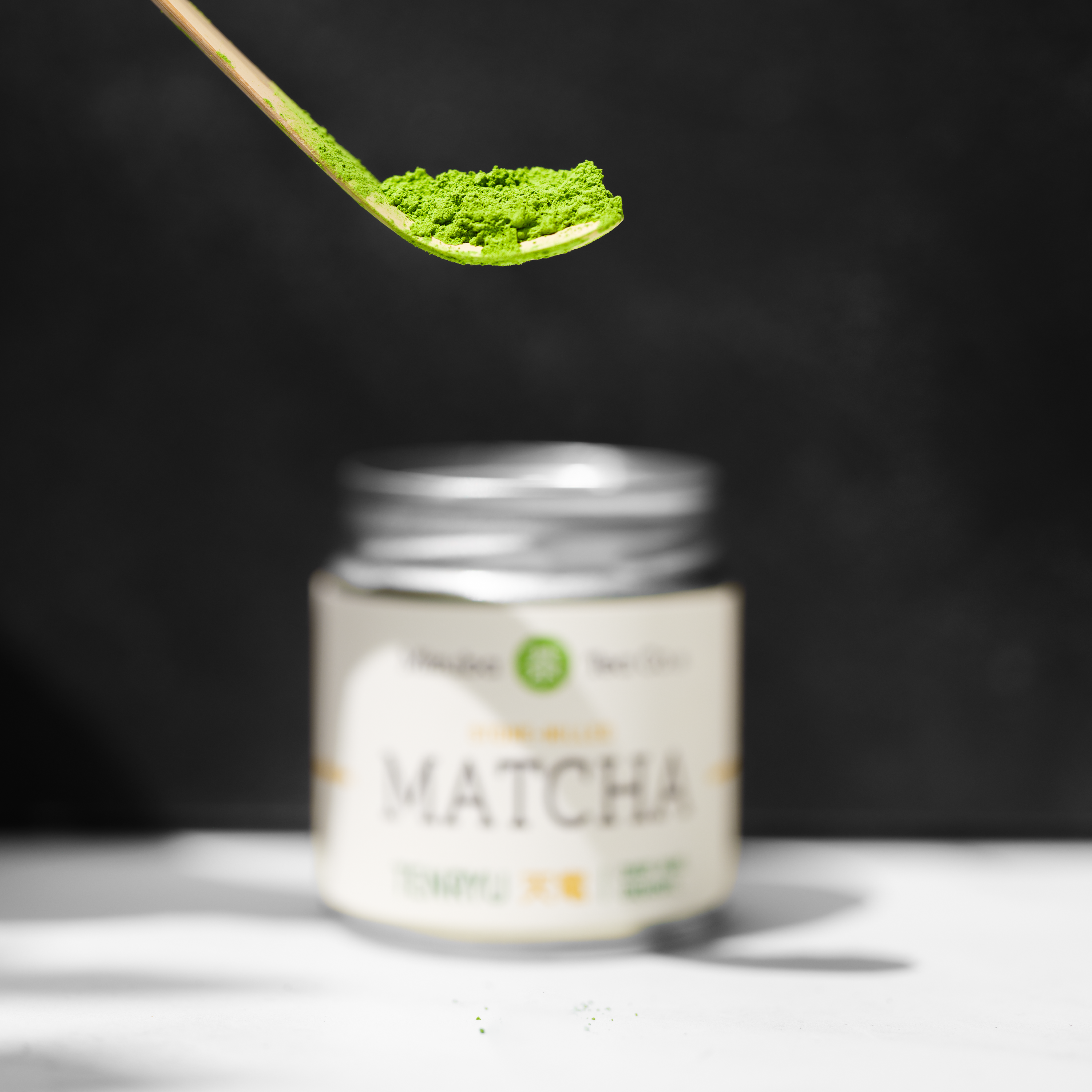 A close up of a chasen matcha school with matcha. 