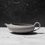 Tea pot for matcha green tea on a white counter
