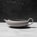 Tea pot for matcha green tea on a white counter