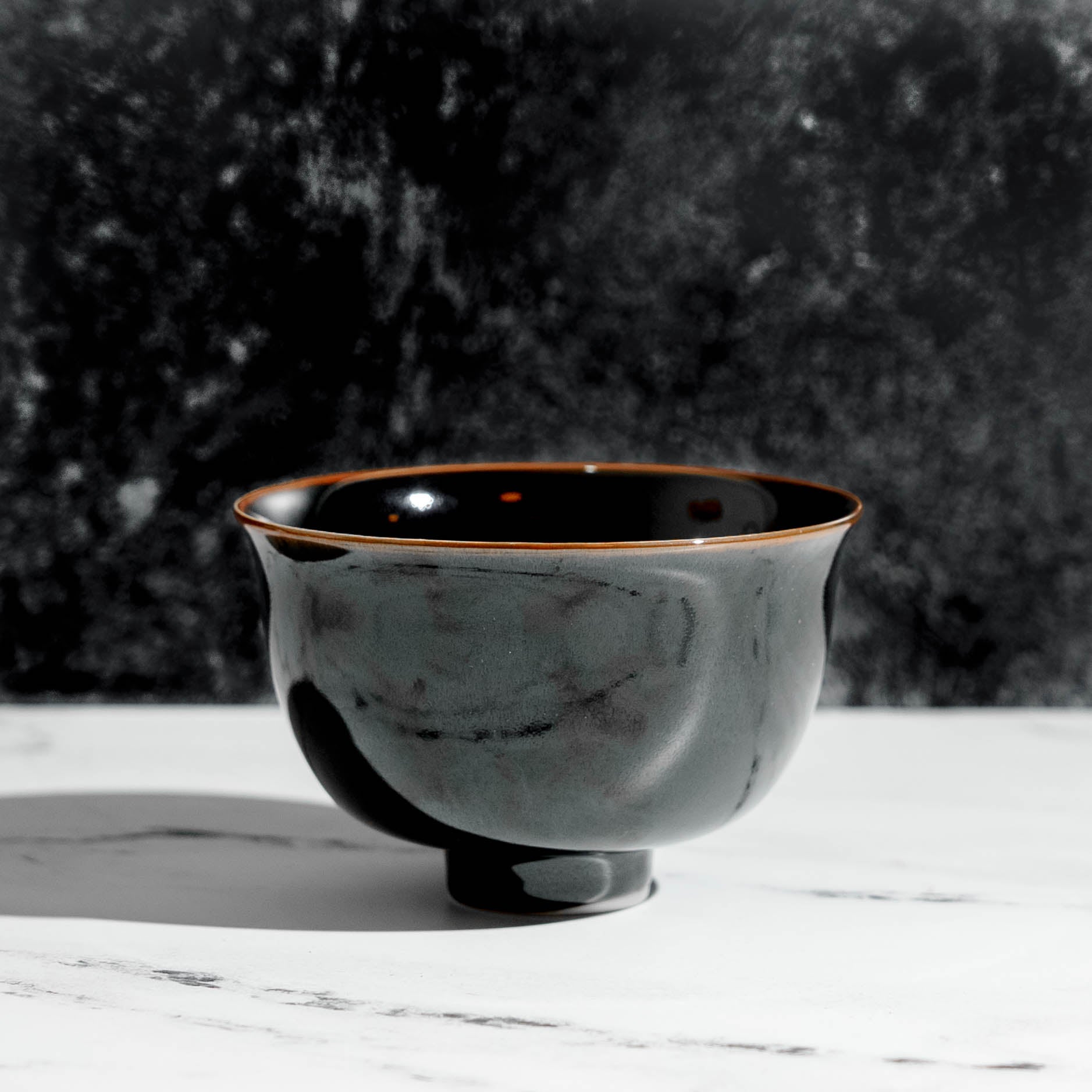 Black porcelain chawan matcha tea bowl on a table – Mizuba Tea Co. 